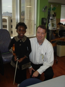Carol Mulumba with Dr. Michael Grimley of Methodist Children's Hospital.