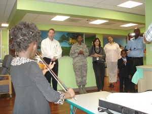 Carol plays the violin for, from left to right, Dr. Michael Grimley, mother Lukiah Mulumba, Dr. Veronica Jude, Transplant Coordinator Denise Lim, brother Mark and father Abudallah Mulumba.